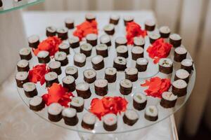 Sushi bar among catering banquet table. Variety of snacks, appetizers, seafood and cooked meals displayed as buffet for wedding, Christmas, business corporate, birthday party or other event photo