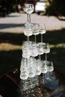 Champagne glasses are laid out in a pyramid. Alcohol. photo