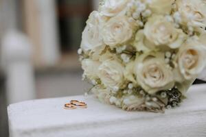 a wedding bouquet of white roses stands in nature photo