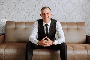 Portrait of smiling successful Caucasian man in formal suit, posing in room, happy young male boss or CEO looking at camera, showing confidence and strength, leadership concept photo