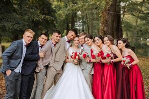 Wedding photo session in nature. The bride and groom and their friends