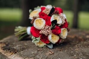 a wedding bouquet of red roses stands in nature photo