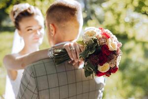 Wedding couple on a walk in the autumn park. The bride in a beautiful white dress. Love and relationship concept. Groom and bride in nature outdoors photo