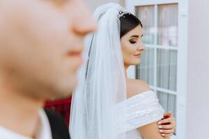 The moment of the first meeting of the bride and groom with a wedding bouquet, the bride is waiting for her lover. photo