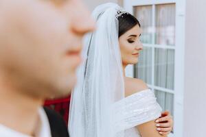 The moment of the first meeting of the bride and groom with a wedding bouquet, the bride is waiting for her lover. photo