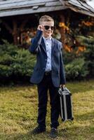 a little boy imitates a businessman. photo