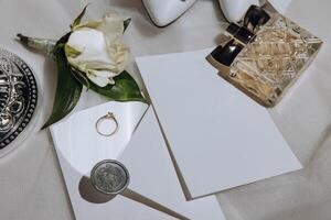 Bride's wedding ring on high-heeled shoes, women's perfume, wedding glasses. Wedding details. High quality photo