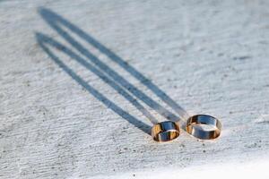 Two wedding rings on a wooden stand photo