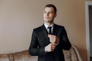 Portrait of smiling successful Caucasian man in formal suit, posing in room, happy young male boss or CEO looking at camera, showing confidence and strength, leadership concept photo