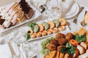 Top view of a beautifully decorated table with delicious food. Everything is ready for lunch or dinner with delicious snacks and a cozy atmosphere. photo