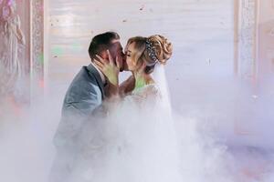 Happy bride and groom and their first dance, wedding in the elegant restaurant with a wonderful light and atmosphere photo