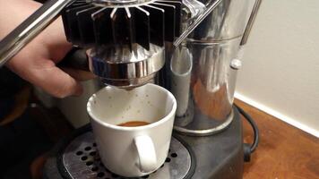 Small HD video of the preparation of an espresso with the steam machine. The coffee is dripping.