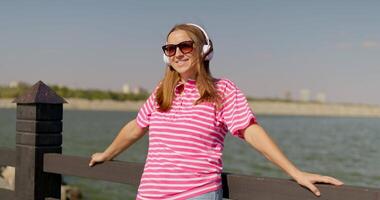 Young Woman Enjoying Music by the Lake video