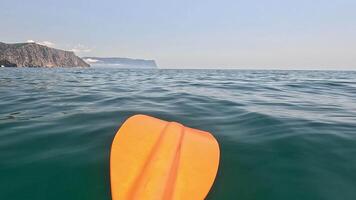 Sea water surface background. Low angle view from kayak, camera flies over the clear green sea water. Nobody. Holiday recreation concept. Abstract nautical summer ocean nature. Slow motion. video