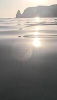 Sea water surface. Low angle view from kayak, camera flies over clear sea water. Nobody. Holiday recreation concept. Abstract nautical summer ocean nature. Slow motion. Close up. Vertical video