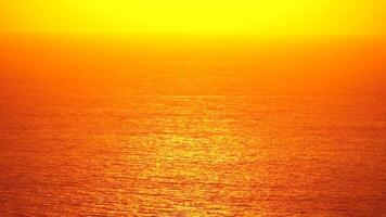 Sea water surface. Aerial view on golden sea water at sunset. Sun glare. Abstract nautical summer ocean nature. Holiday, vacation and travel concept. Nobody. Slow motion. Weather and climate change video