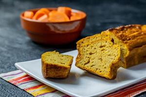 Deep orange carrot cake on a dark background. photo