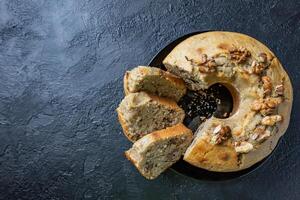 Walnut cake on a dark table. Moist and healthy walnut cake. photo