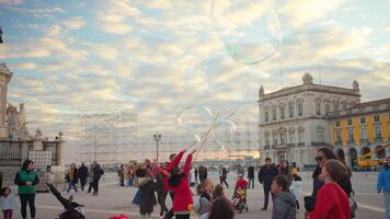 Children enjoying soap bubble show on Commerce Square in Lisbon video