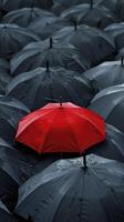 AI generated A red umbrella among the black umbrellas. Contrast concept. photo