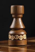 Chess piece of wood black rook. A puzzle game with tricky combinations that requires planning and thinking. photo