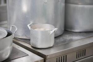 Metal pots on an industrial stove photo