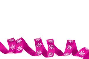 Christmas ribbon pink with white snowflakes with copy space. photo