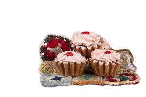 Beautiful sweets. Cakes basket with pink cream decorated with red berries. photo