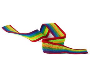 Colorful rainbow ribbon closeup isolated on white background. Colorful LGBT design. Curly, fluttering ribbon. photo