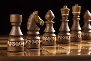 Chess dark pieces on a chess field. A puzzle game with tricky combinations that requires planning and thinking. photo