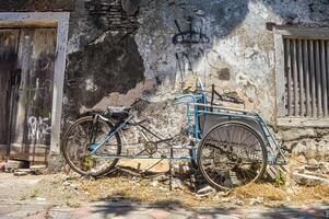 an abandoned rickshaw in a dull old building, Indonesia 17 September 2023. photo