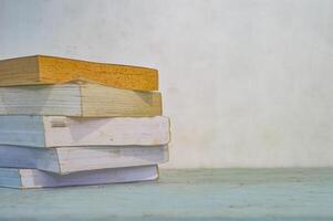 an untidy pile of books on the table photo