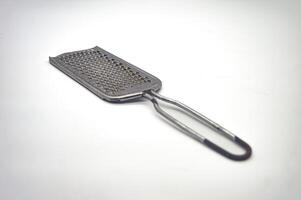 a stainless steel cheese grater isolated on a white background photo