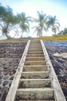 a concrete staircase in the mountains with stone walls photo