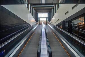 two escalators leading up from the futuristic-looking basement of the Surabaya city square photo