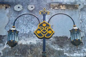 a garden lamp ornament against a weathered walls background photo