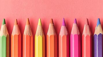 AI generated Vibrant Colored Pencils Arranged on Soft Coral Background Ideal for Copy Space and Creative Design photo