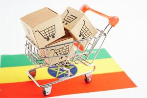 Online shopping, Shopping cart box on Ethiopia flag, import export, finance commerce. photo