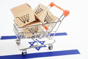 Online shopping, Shopping cart box on Israel flag, import export, finance commerce. photo