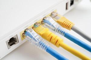 Ethernet cable with wireless router connect to internet service provider network. photo