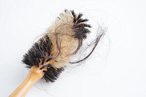 Hair loss fall with comb brush isolated on white background. photo