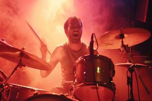 AI generated male drummer playing the drums in the concert bokeh style background with generative ai photo