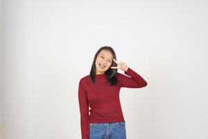 Young Asian woman in Red t-shirt smiling and showing peace or victory sign showing  isolated on white background photo