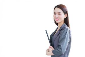 Young asian professional business office woman holds document file in her hands standing confidently in workplace while isolated white background. photo