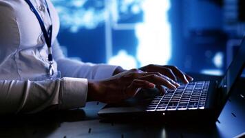 System administrator writing artificial intelligence script code in startup workspace on laptop terminal. Computer operator doing maintenance work in high tech facility updating AI systems photo