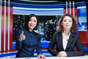 Diverse reporters talk about latest events live on television channel, hosting late night show with exclusive information and breaking news. Journalists media team presenting global issues. photo