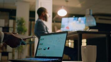 Manager holding online teleconference meeting with colleagues working from home while assistant prepares necessary paperwork. Management executive chatting with employees in videocall photo