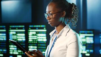 Meticulous tech support woman strolling through server rows providing processing resources for different workloads. Supervisor overseeing supercomputers tasked with solving complex operations photo