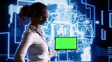 Tech savvy admin in data center with mockup tablet using artificial intelligence computing simulating human brain thought processes. African american woman working with AI neural network algorithms photo