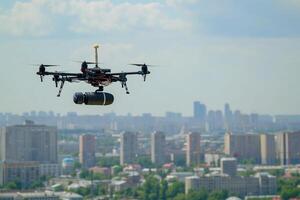 AI Generated Copter drone carrying a bomb above city at summer day photo